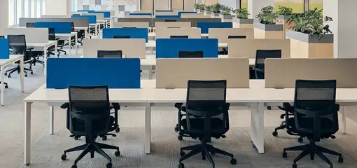 Modern open-plan office space featuring clean workstations, ergonomic chairs, and sanitized carpets provided by professional office cleaning services in Reno, NV.