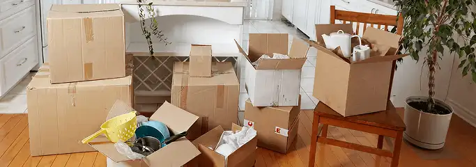 Packed moving boxes and household items in a kitchen before move-out or move-in cleaning, Reno, NV.